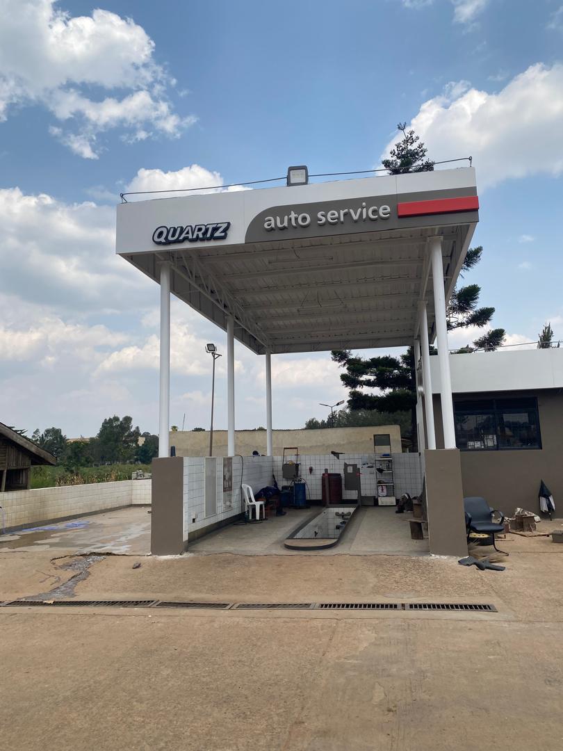 Quartz auto service bay with branded canopy